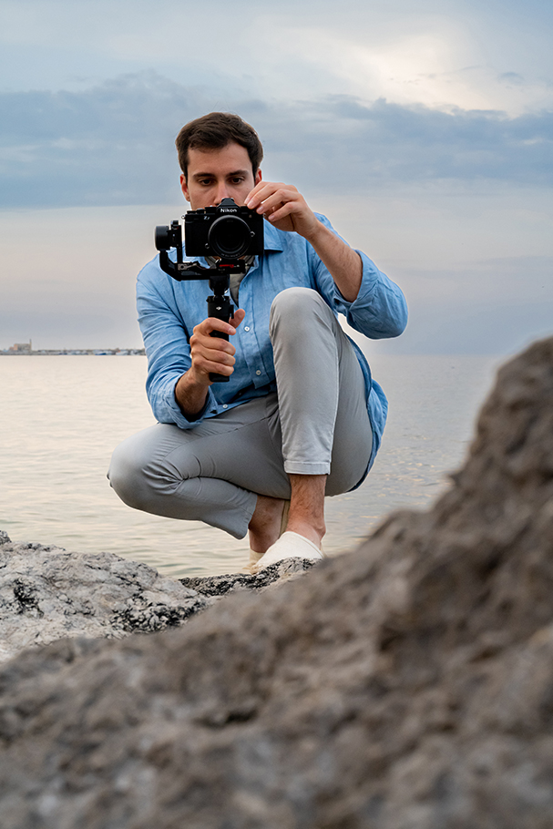 Man crouching down holding Nikon Z f camera| Nikon Cameras, Lenses & Accessories