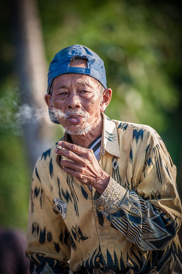 Elderly Asian man enjoying a cigarette photographed by G Gunawan | Nikon Cameras, Lenses & Accessories