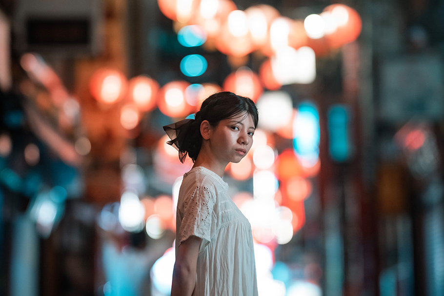 Girl with city lights behind her | Nikon Cameras, Lenses & Accessories