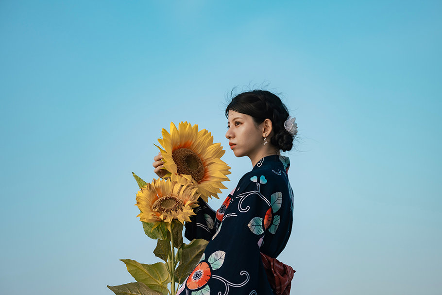 Girl with sunflowers against blue sky | Nikon Cameras, Lenses & Accessories